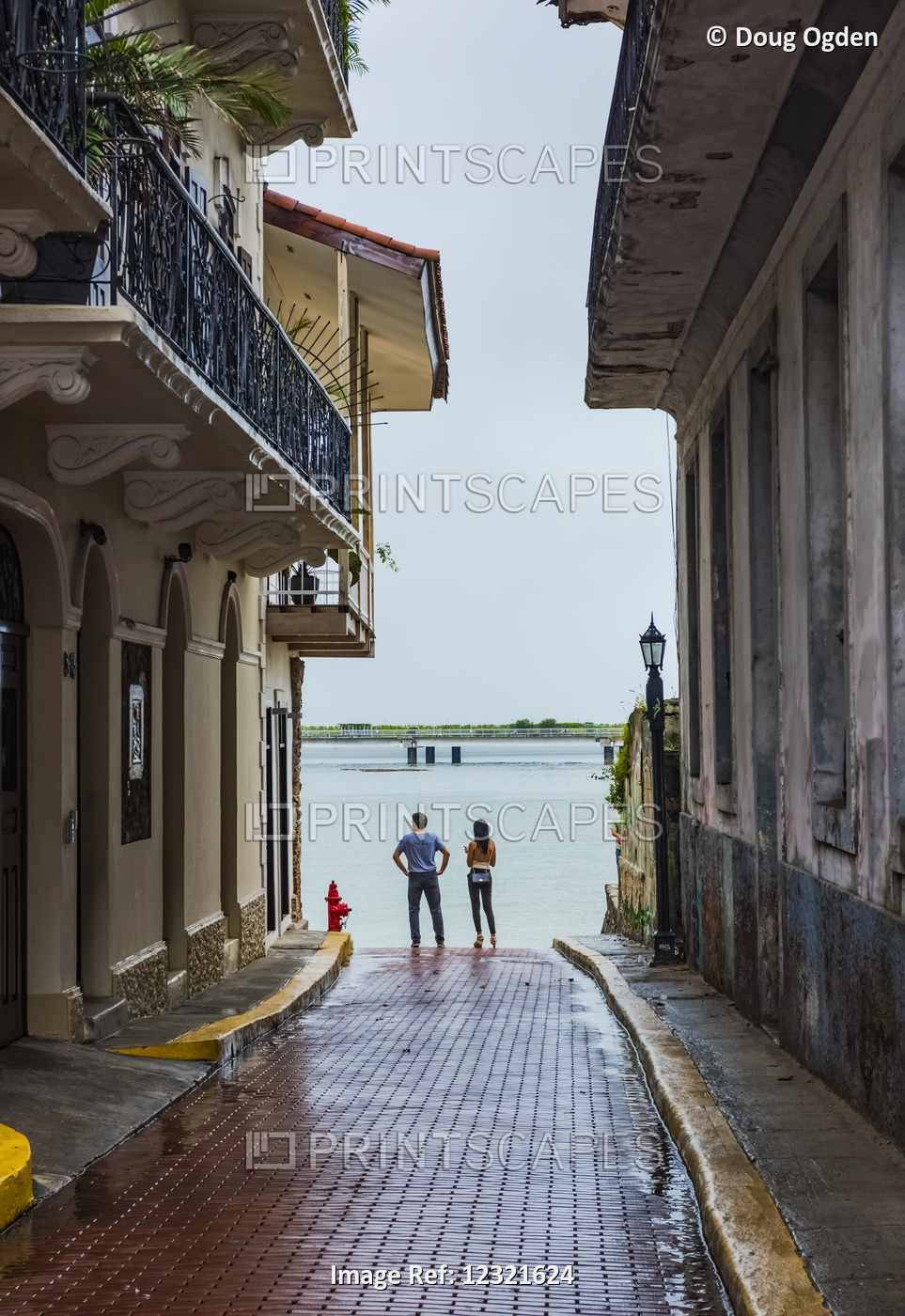 A Young Couple Take In The View From The End Of A Casco Viejo Alley That ...
