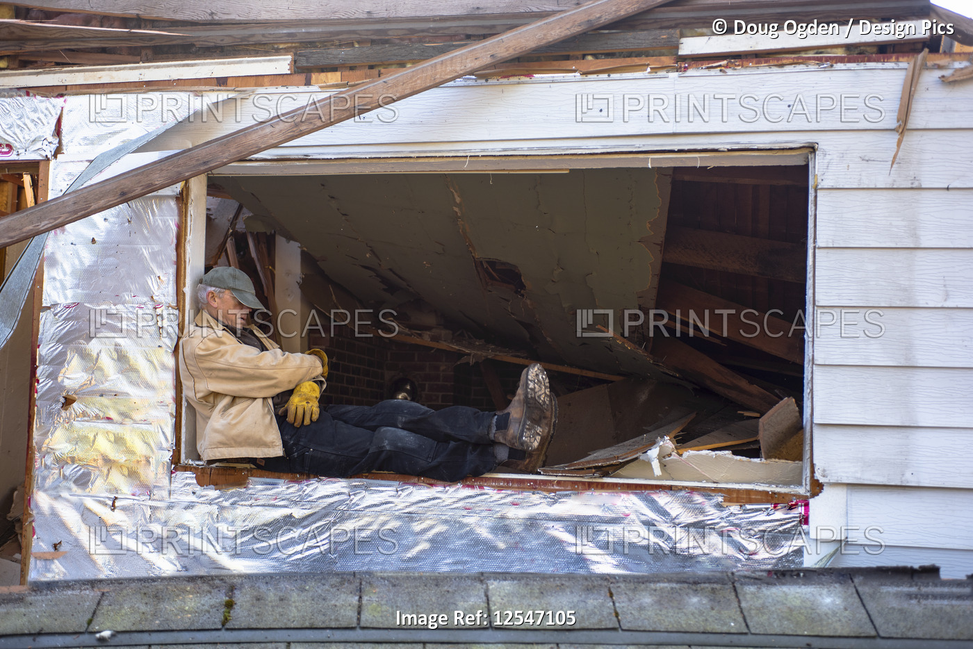Man snoozing on a worksite, sitting on the ledge of an open window under ...