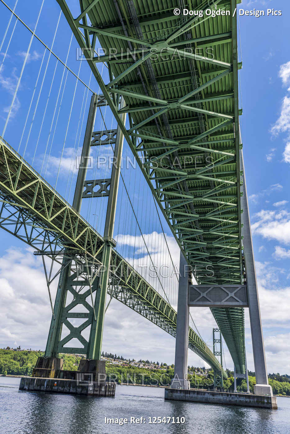 A view of the Tacoma Narrows Bridges from the water surface.  The bridges span ...