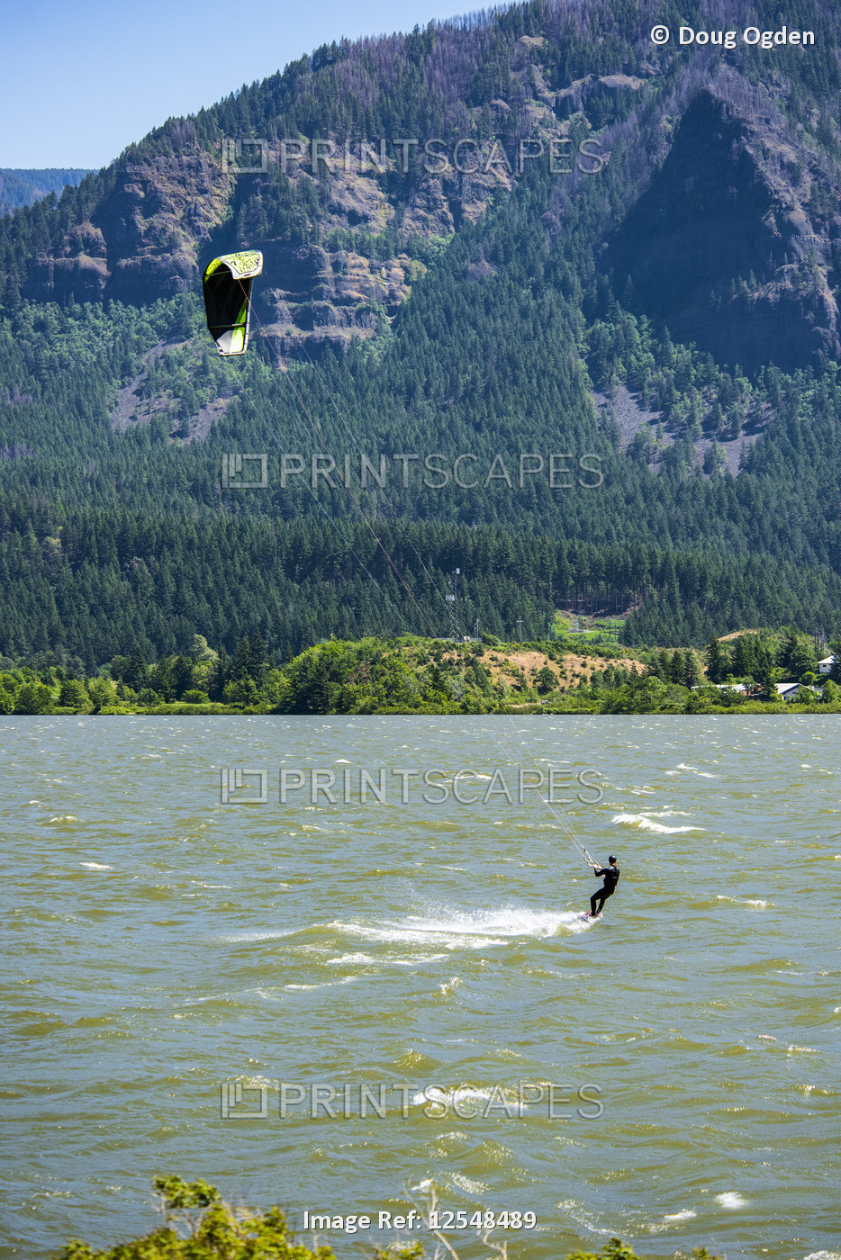 A kite surfer enjoying the strong spring winds up the Columbia River Gorge at ...