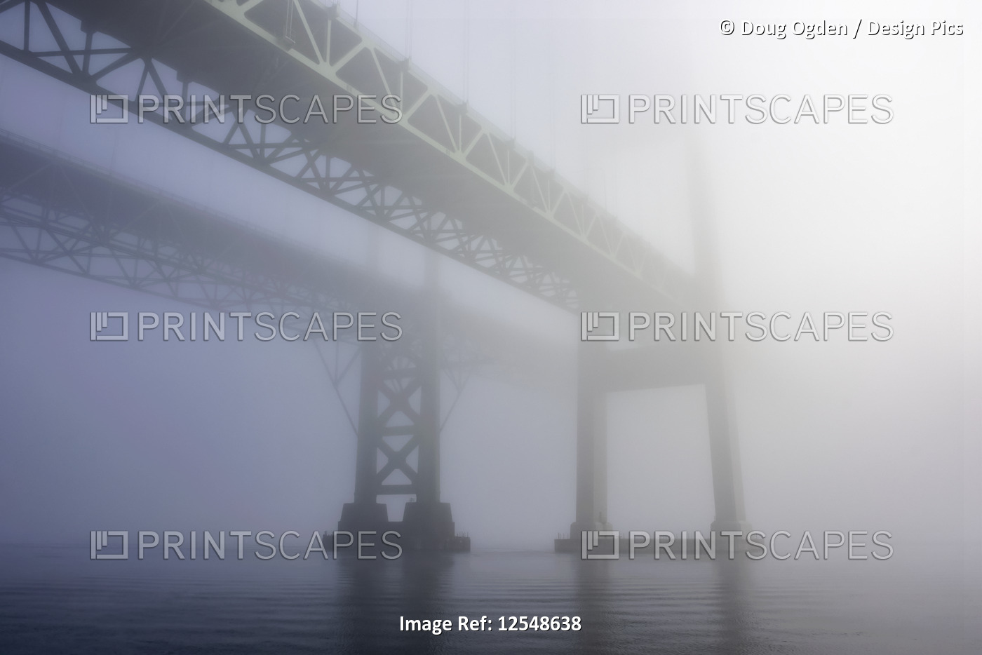 The Tacoma Narrows Bridges in the fog from the water surface.  The bridges ...