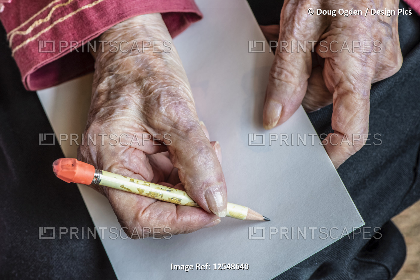 Senior woman's hands getting ready to write a note with a pencil; Olympia, ...