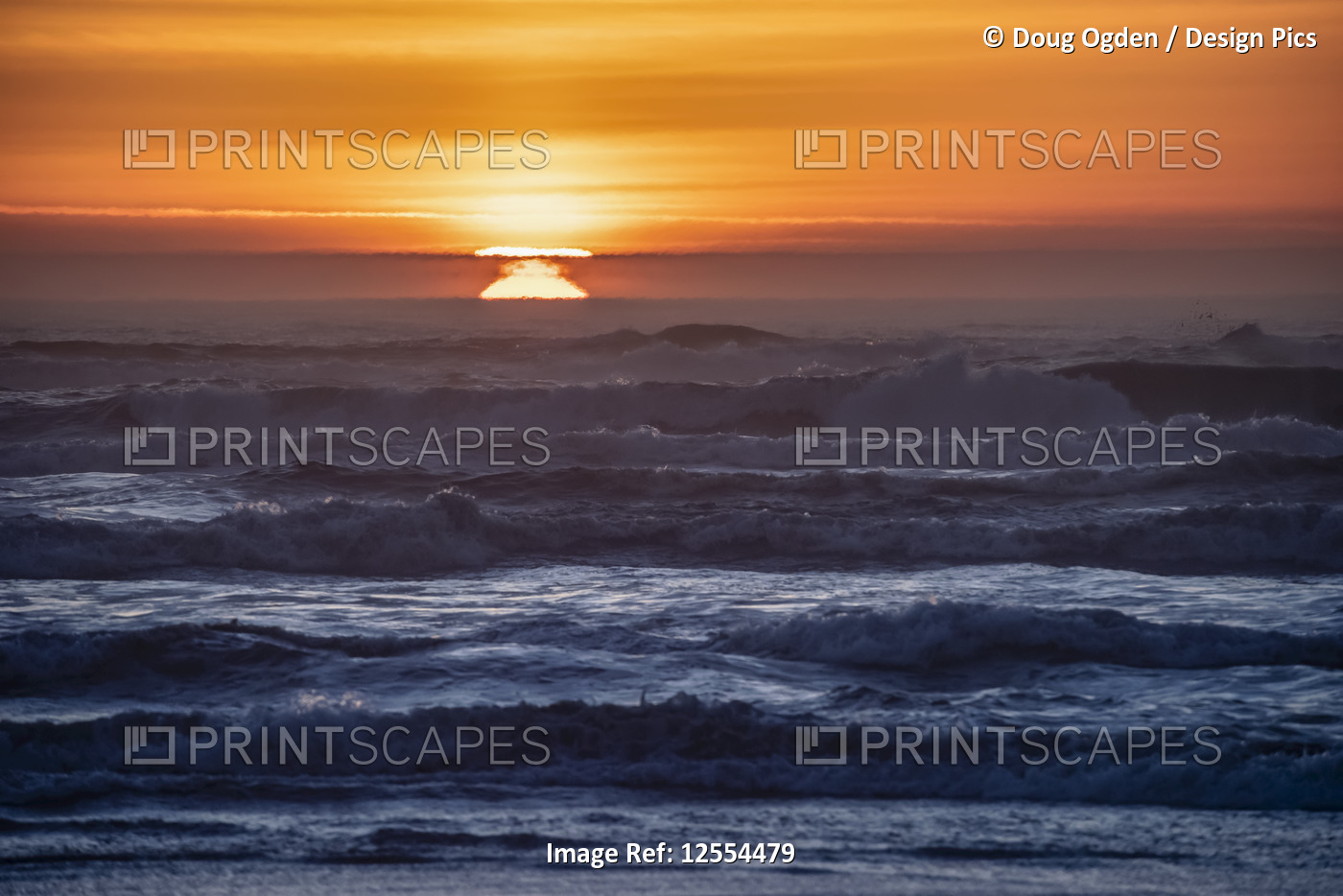 Sunset over the waves at Cape Disappointment, Washington.  The atmospheric ...