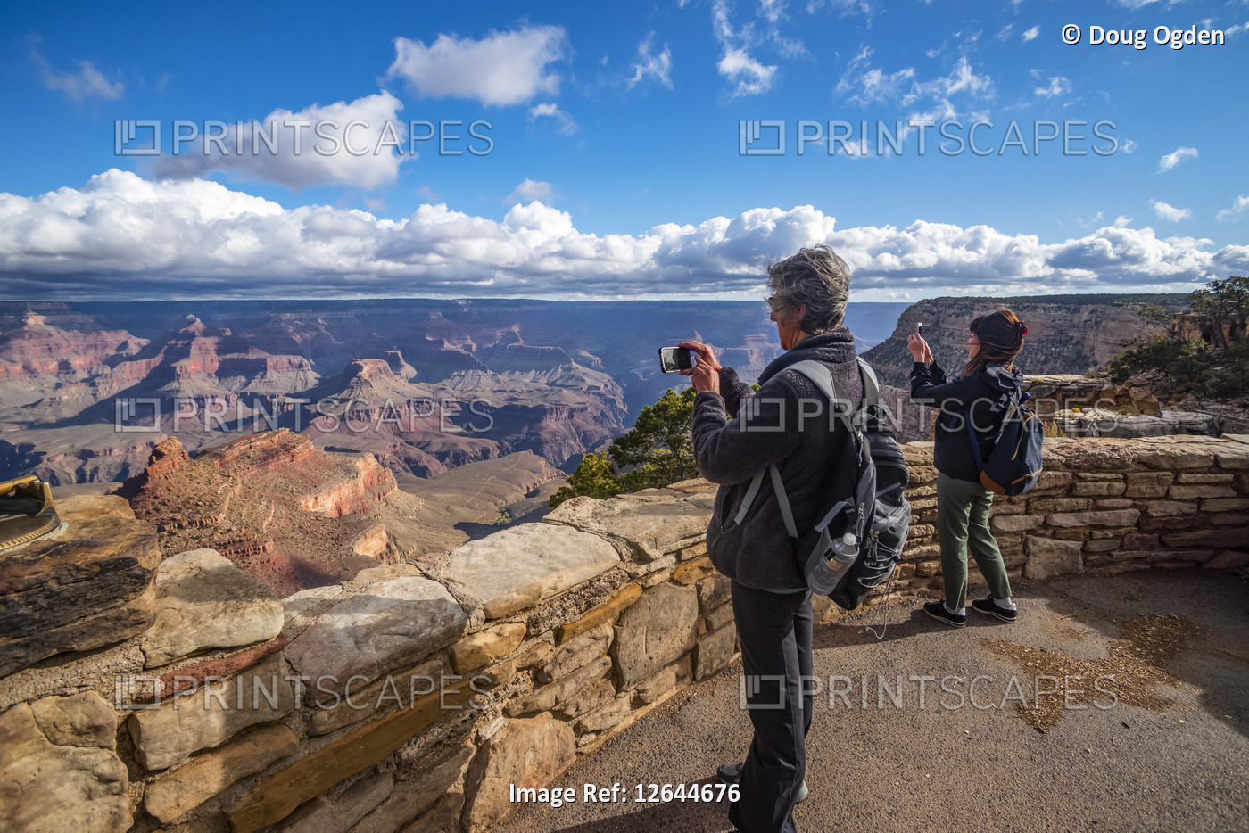 Tourists taking photos of the views of the Grand Canyon from the Rim Trail near ...