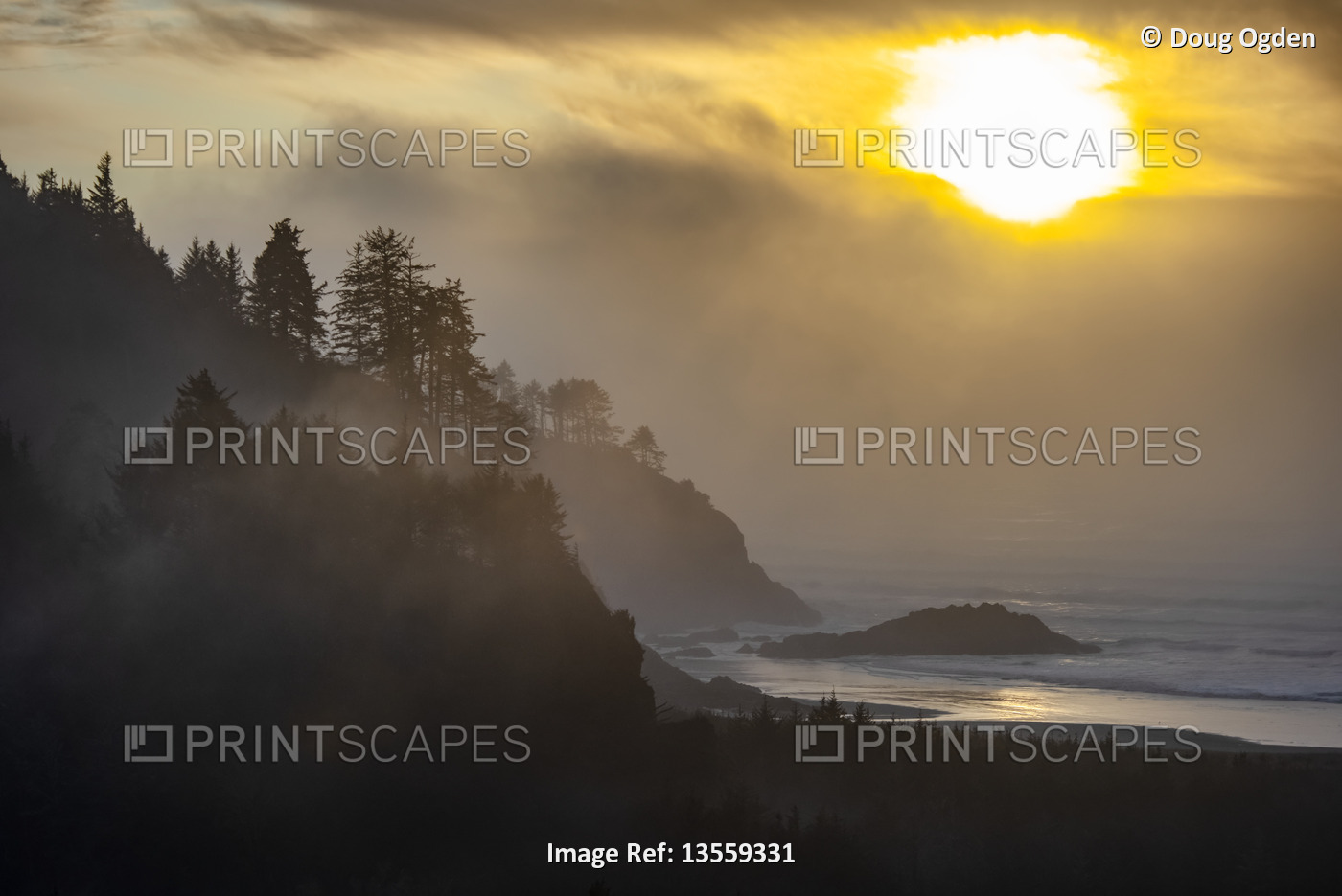 View of Cape Disappointment with a bright, golden sun glowing through the dark ...