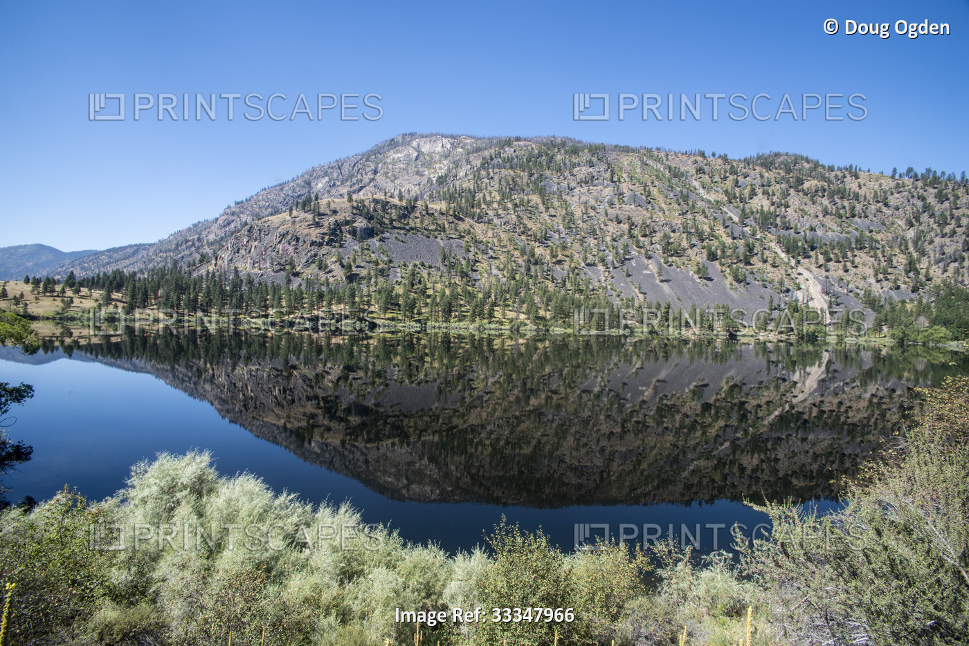 Mountain scene reflected on the pristine Blue Lake in Eastern Washington at the ...