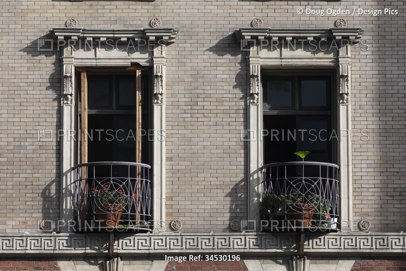 Decorative balconies on a residential building. The wrapped wrought iron ...