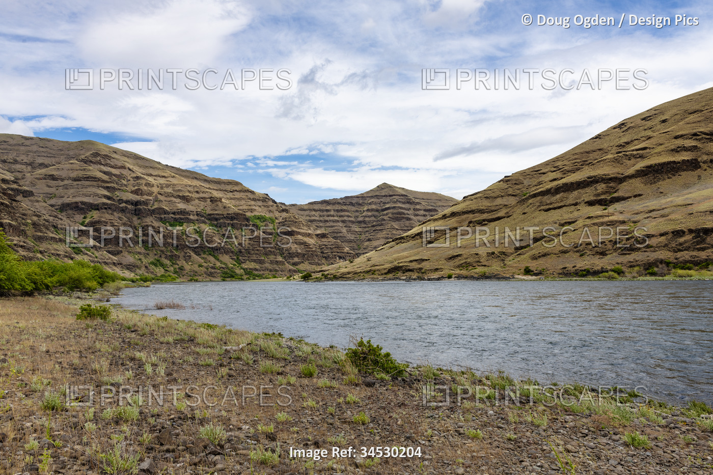 Wild Snake River and the exposed geologic and eroding cliffs as seen from the ...