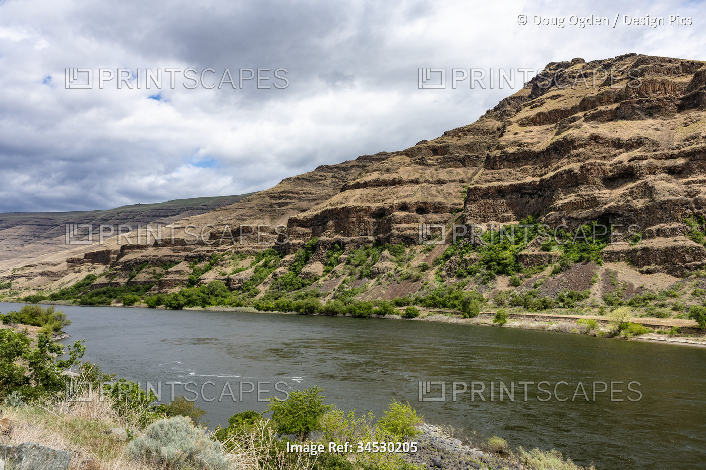 Wild Snake River and the exposed geologic and eroding cliffs as seen from the ...