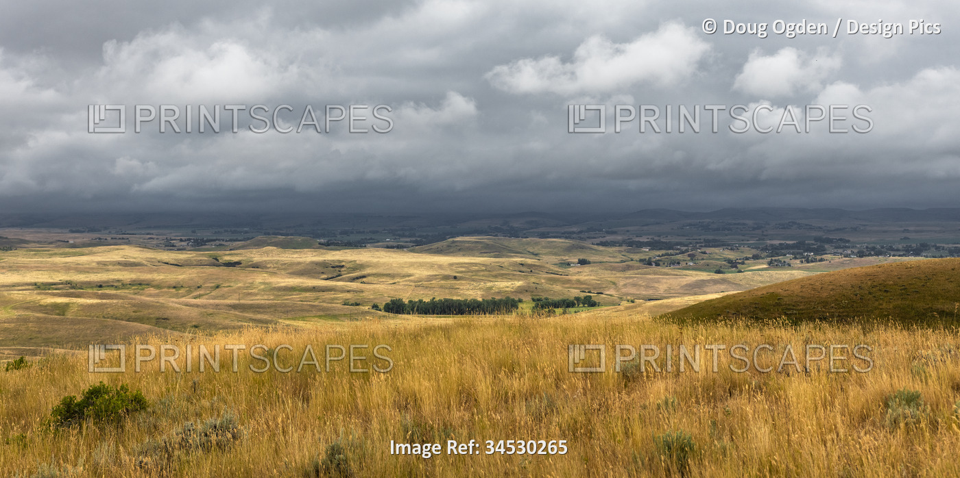 View of the rolling hills and threatening weather from the Bozeman Trail Head ...